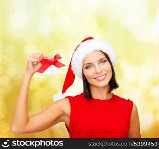 christmas, x-mas, winter, happiness concept - smiling woman in santa helper hat with jingle bells