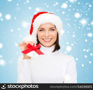 christmas, x-mas, winter, happiness concept - smiling woman in santa helper hat with jingle bells