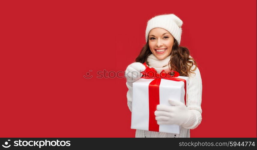 christmas, x-mas, winter, happiness concept - smiling woman in white clothes with gift box