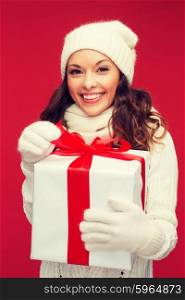 christmas, x-mas, winter, happiness concept - smiling woman in white clothes with gift box