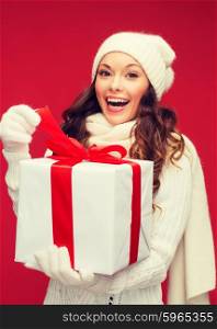christmas, x-mas, winter, happiness concept - smiling woman in white clothes with gift box