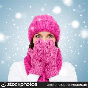 christmas, x-mas, winter, happiness concept - surprised woman in hat, muffler and mittens
