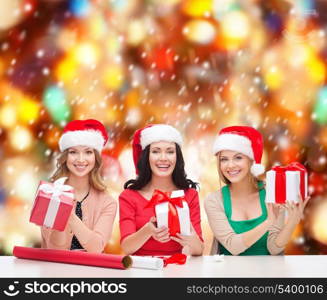 christmas, x-mas, winter, happiness concept - three smiling women in santa helper hats with many gift boxes