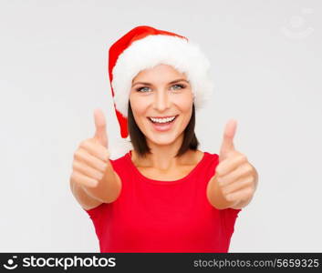 christmas, x-mas, winter, happiness concept - woman in santa helper hat showing thumbs up