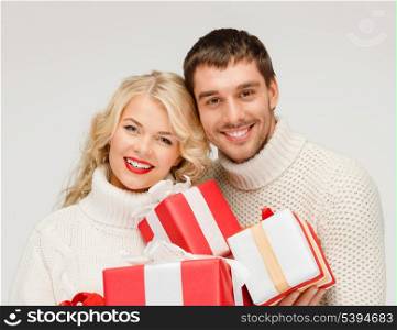 christmas, x-mas, winter, valentine&#39;s day, birthday, couple, happiness concept - smiling woman and man with many gift boxes