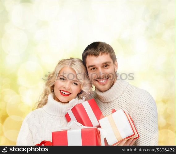 christmas, x-mas, winter, valentine&#39;s day, birthday, couple, happiness concept - smiling woman and man with many gift boxes