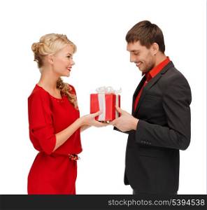 christmas, x-mas, winter, valentine&#39;s day, birthday, happiness, couple concept - smiling woman and man with gift box