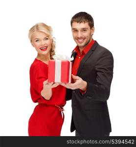 christmas, x-mas, winter, valentine&#39;s day, birthday, happiness, couple concept - smiling woman and man with gift box