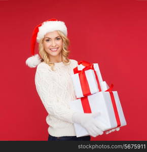 christmas, xmas, winter, happiness concept - smiling woman in santa helper hat with many gift boxes