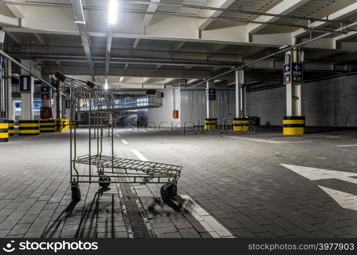 Chrome store trolley at underground parking with illuminated background