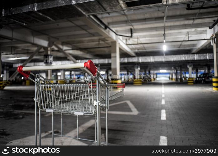 Chrome store trolley at underground parking with illuminated background