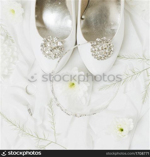 chrysanthemum wedding rings crown near wedding shoes scarf