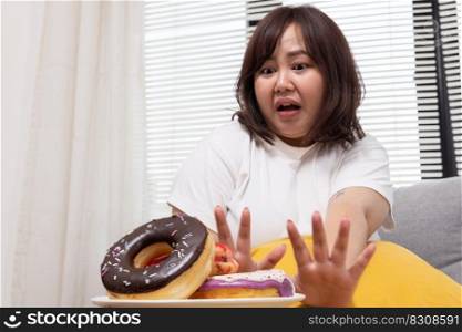 Chubby Asian Woman Try to Stop Herself From Eating Doughnut