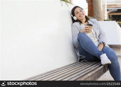 chubby girl enjoying coffee outdoors