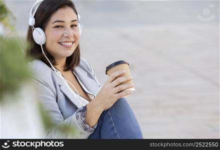 chubby girl listening music outdoors 2
