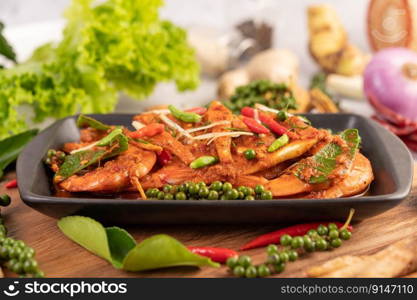 Chuchi shrimp on a plate with fresh pepper seeds. Selective focus.