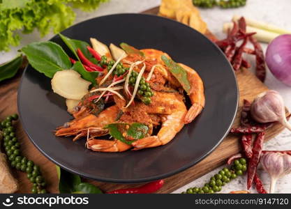 Chuchi shrimp on a plate with fresh pepper seeds. Selective focus.