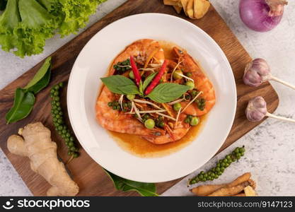 Chuchi shrimp on a plate with fresh pepper seeds. Selective focus.