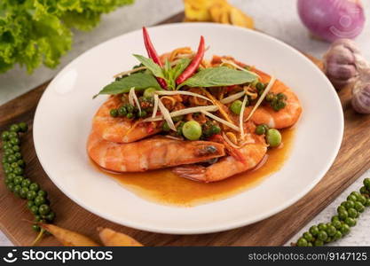 Chuchi shrimp on a plate with fresh pepper seeds. Selective focus.