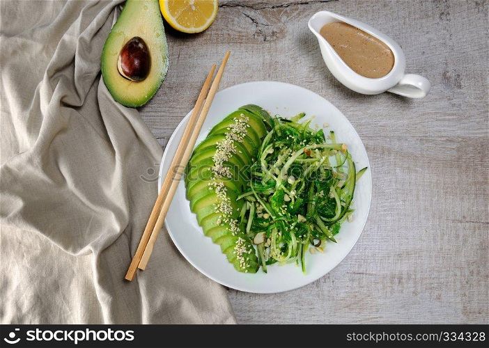Chukka salad, cucumber noodles with avocado and peanut brown sauce in sauce boat