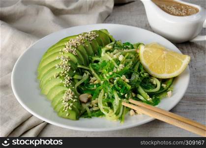 Chukka salad, cucumber noodles with avocado and peanut brown sauce in sauceboat