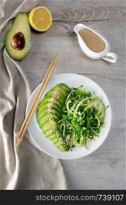 Chukka salad, cucumber noodles with avocado and peanut brown sauce in sauceboat