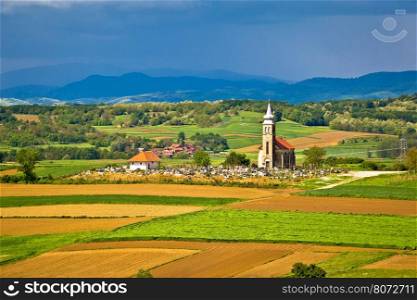 Church and graveyard on picturesque landscape, region of Prigorje, Croatia