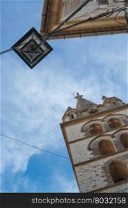 Church building street light and blue sky in Binissalem, Majorca, Spain.