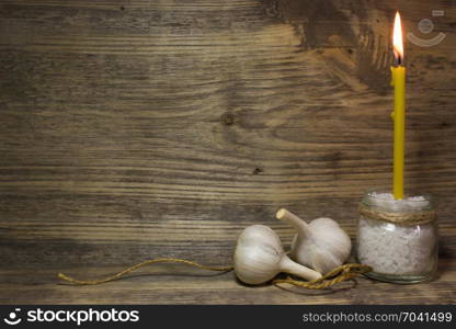 Church burning candle on wooden background