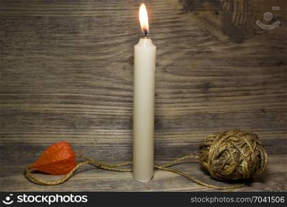 Church burning candle on wooden background