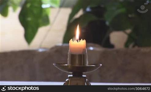 church candle shining on a stand