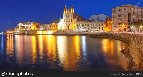 Church of Our Lady at night, Saint Julien, Malta. Panorama of Balluta Bay and Neo-Gothic Church of Our Lady of Mount Carmel, Balluta parish church, during evening blue hour, Saint Julien, Malta