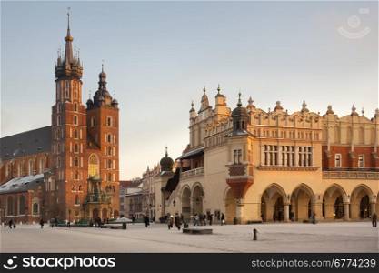 Church of St. Mary and the Cloth Hall in the main Market Square (Rynek Glowny) in the city of Krakow in Poland.