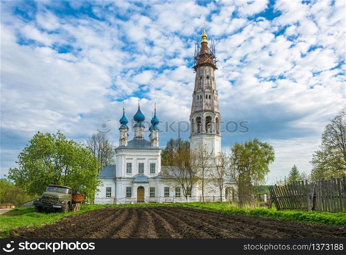 Church of the Holy Archangel Michael and the bodiless hosts in the village of Mikhailovskoye. In the foreground is a plowed field. Ivanovo oblast, Russia.