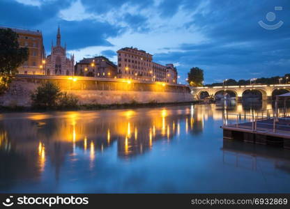 Church of the Sacred Heart in Prati, Rome, Italy. Tiber riverside with Church of the Sacred Heart of Jesus in Prati and mirror reflection during evening blue hour in Rome, Italy