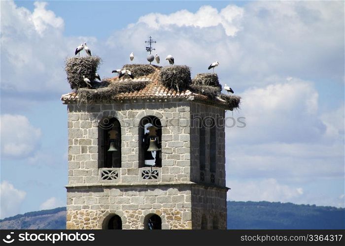 Church tower in Manzanares el Real with storks
