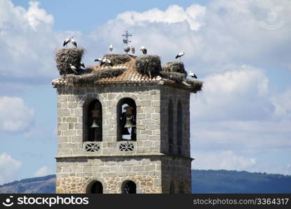 Church tower in Manzanares el Real with storks