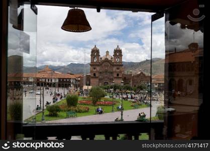 Church viewed through a balcony, Iglesia de la Compania de Jesus, Plaza de Armas, Cuzco, Peru