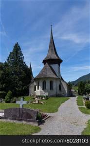 Church with wooden roof and cemetery in Rougemont Vaud canton of Switzerland