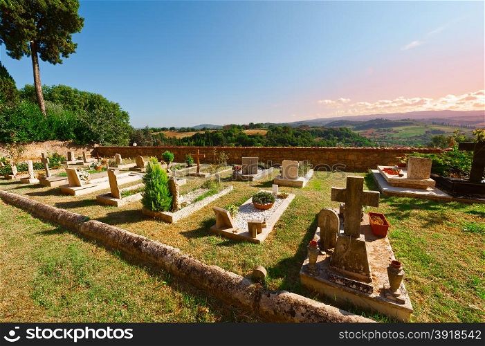 Churchyard on the Background of the Tuscan Landscape at Sunset