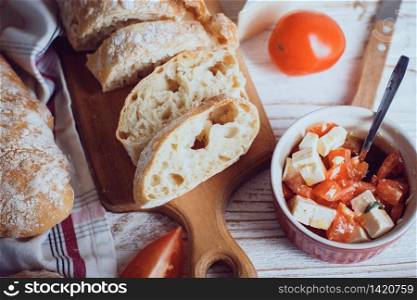 Ciabatta Bread - soft homemade bread. Italian Cuisine. bruschetta with cheese, olive oil and tomatoes
