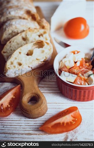 Ciabatta Bread - soft homemade bread. Italian Cuisine. bruschetta with cheese, olive oil and tomatoes