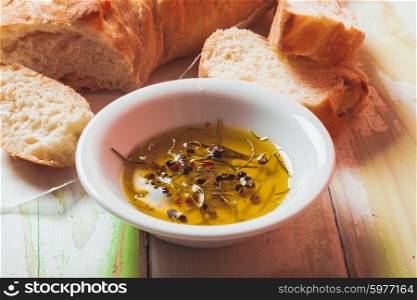 Ciabatta - italian bread with olive oil and spices over wooden table. Ciabatta