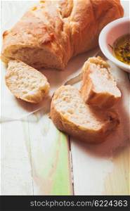 Ciabatta - italian bread with olive oil and spices over wooden table. Ciabatta italian bread