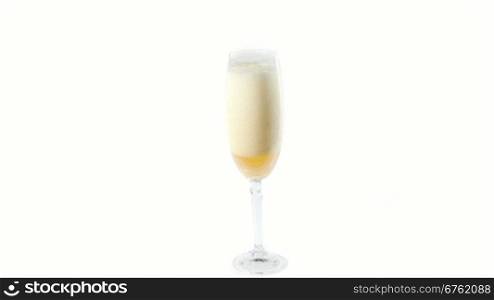 Cider flowing into the glass with bubbles isolated on white