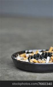 Cigar and ashes on ashtray