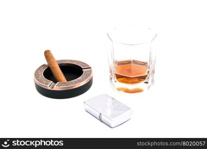 cigar in ashtray, cognac and lighter on white closeup