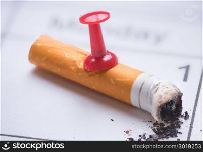 Cigarette butt on calendar. Time to quit smoking concept