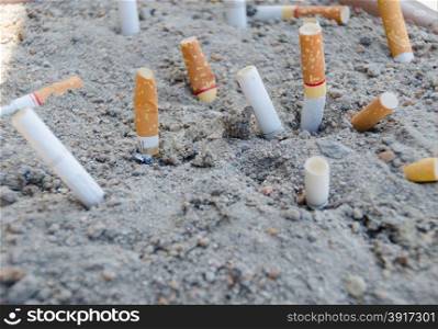 cigarette stub on sand waste product