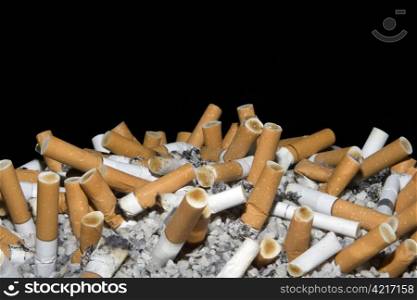Cigarettes in ashtry isolated on black background